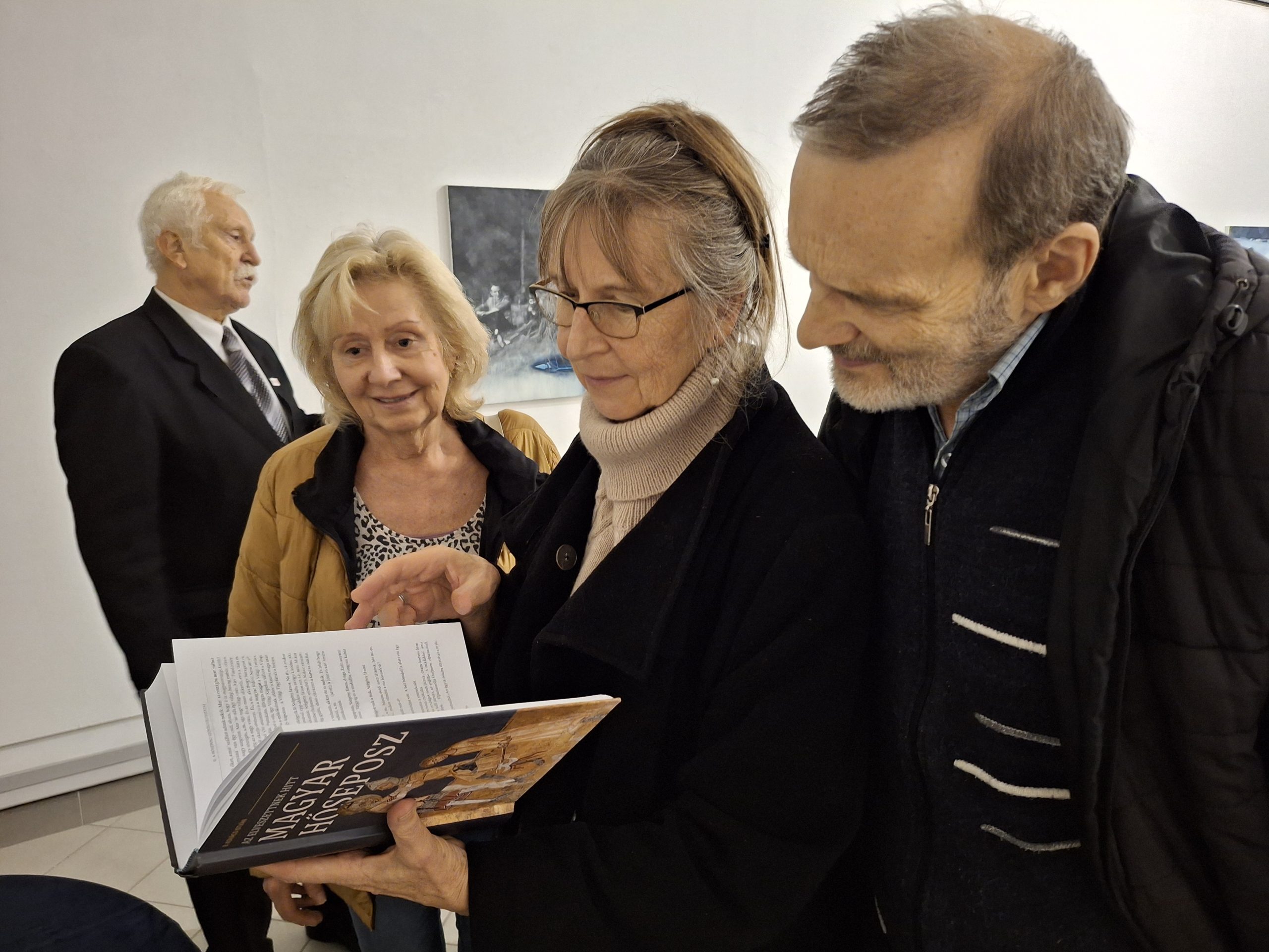 emberek egy könyvet néznek